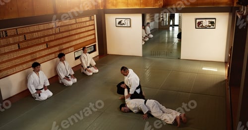 Preview: Men in dojo with sensei for aikido training, fitness and development with action, exercise and coac
