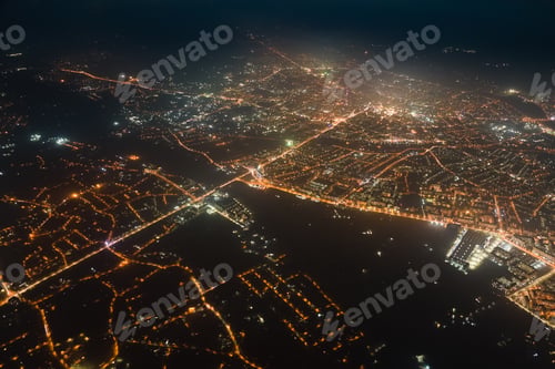 Preview: Aerial view from airplane window of buildings and bright illuminated streets in city residential