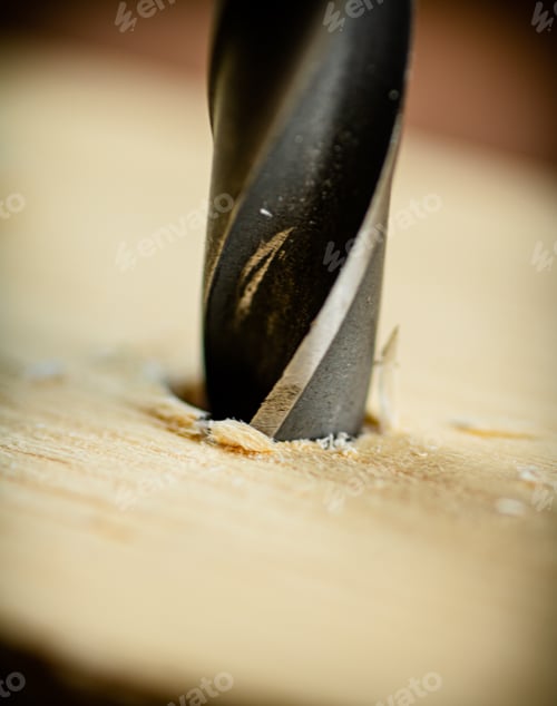Preview: Piece of wood is drilled with shavings.