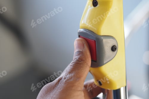 Preview: Hand pressing stop button on public transport vehicle