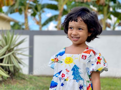 Preview: Kid smiling standing in the garden