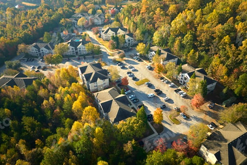 Preview: Aerial view of new apartment houses between yellow trees in South Carolina