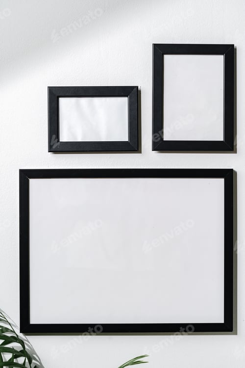 Preview: Three blank frames with copy space hanging on white wall