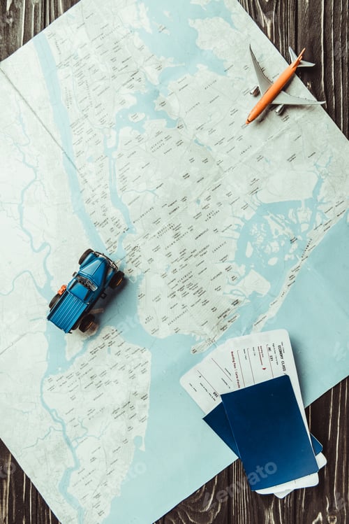 Preview: flat lay with map, toys, passports and tickets on dark wooden tabletop