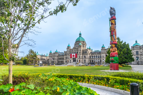 Preview: Totem pole standing proudly in front of parliament buildings in victoria, british columbia