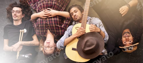 Preview: Our bands on its way to the top. High angle portrait of a band lying on the stage after a gig.