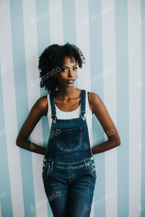 Preview: Pretty african american woman posing in jeans trousers