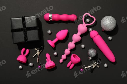 Preview: Sex toys with Christmas decorations on a dark background.