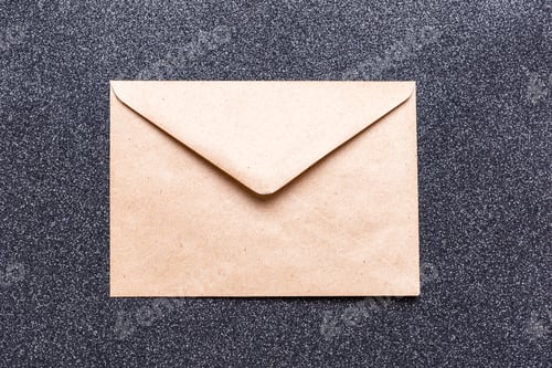 Preview: Closed brown craft envelope on dark background. An envelope for your congratulations. Zero waste