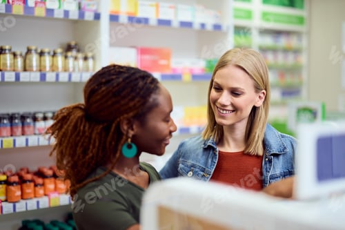 Preview: Women Engaged in Friendly Conversation in a Modern Pharmacy Environment