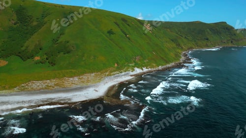 Vista previa: Wild nature, green mountains with steep green slopes leading to the sea. Clip. Aerial of foam of