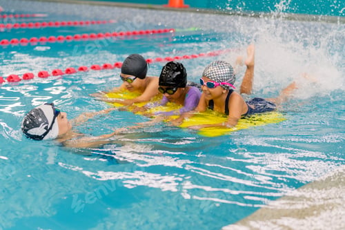 Preview: Children learning swimming with instructor and kickboards