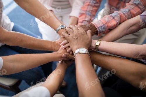 Preview: Cropped image of senior people and female doctor stacking hands