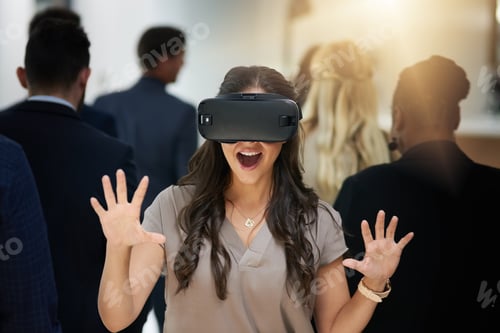 Preview: Who knows what youll discover. Shot of a young businesswoman wearing a VR headset in a busy office.
