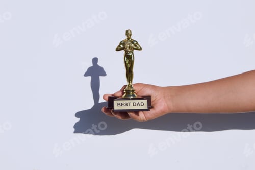 Preview: NOMINATED Holding a BEST DAD award and trophy on a white background with cool shadow