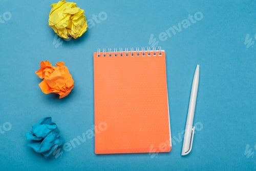 Preview: Office workspace with an empty notebook, crumpled paper