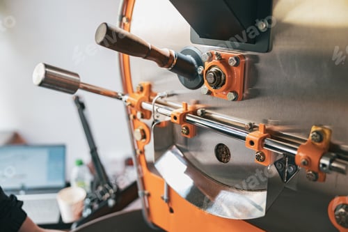 Preview: Close up of coffee roasting machine with coffee beans in small coffee manufacturing
