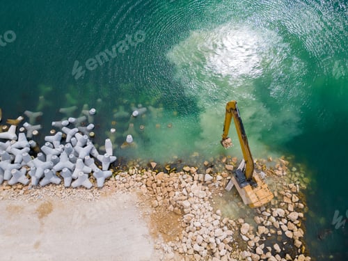 Preview: An excavator diligently constructs a dock or breakwater in the sea, its mighty arm reaching out from