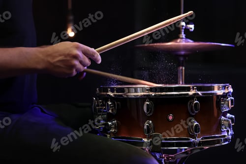 Preview: Drummer playing snare drum with sticks close up.
