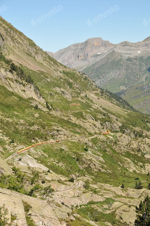 Preview: Train passing a vast mountainous landscape in the countryside