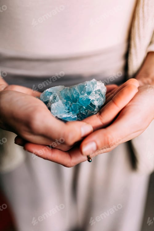 Preview: Woman holding celestine geode indoors