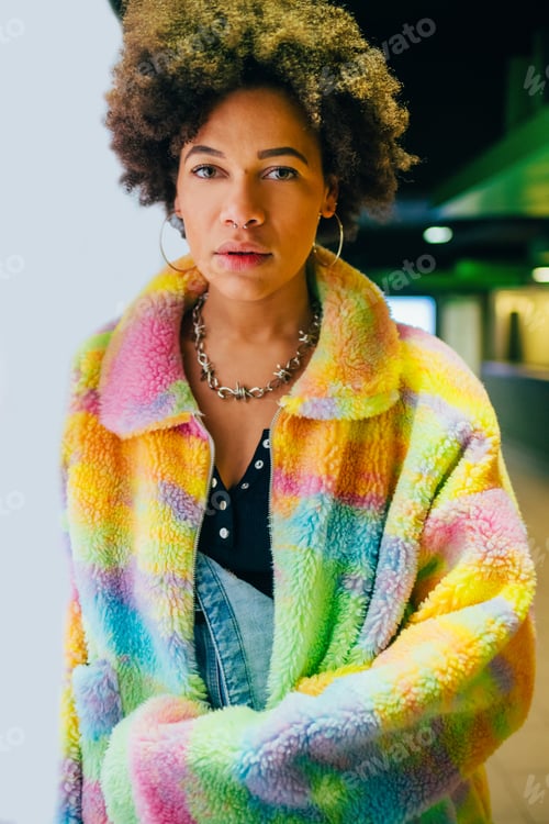Preview: Cool young black woman curly hairstyle posing indoor underground metro station staring
