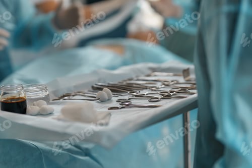 Preview: Surgical instruments and tools including scalpels forceps and tweezers arranged on table for surgery