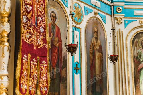 Preview: Gold censers with red candle on icon in church. Church interior and decoration