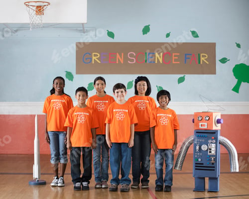 Preview: Students in the Science Club standing under the sign Green Science Fair in a school