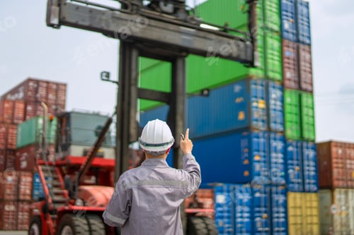 Preview: Blue collar worker is working at container warehouse.