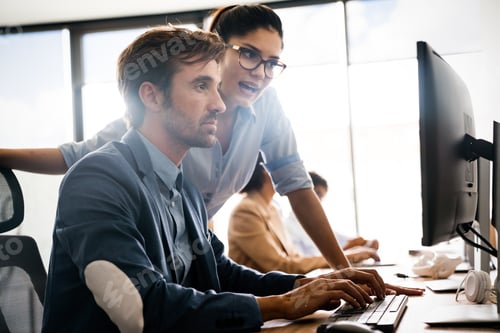 Preview: Group of young business people working and communicating at the office