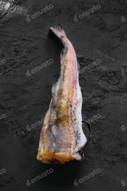 Preview: Frozen raw pollock carcass on wooden table