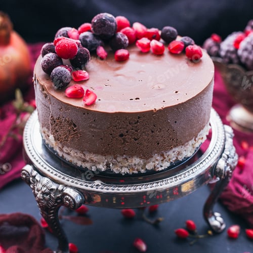 Preview: Sweet chocolate cake with pomegranate seeds and fresh berries on it