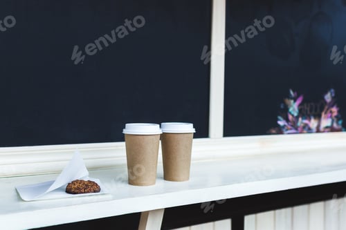 Preview: Two cups of coffee to go and oat cookies at the bar