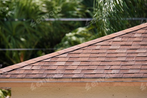 Preview: Closeup of house roof top covered with asphalt or bitumen shingles. Waterproofing of new building