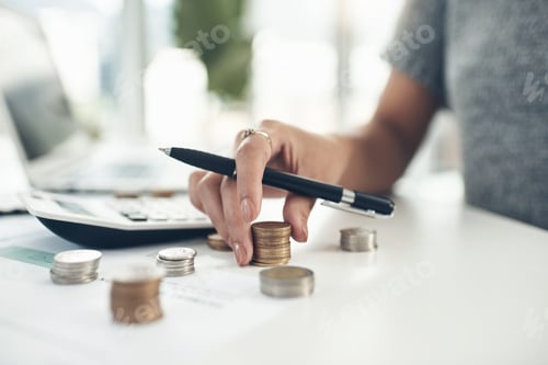 Preview: Closeup shot of an unrecognisable businesswoman calculating finances in an office