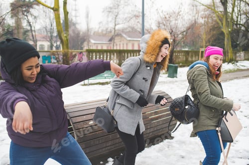 Preview: three young women having fun outdoor in winter day