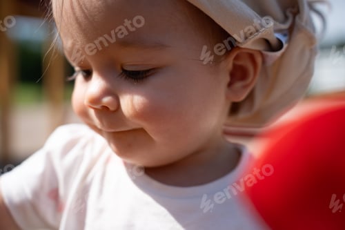 Preview: Child outdoors, gentle sunlight, shadows, highlighting soft expression, delicate features, warm tone