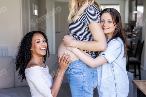 Preview: Happy family with pregnant woman, wife and daughter