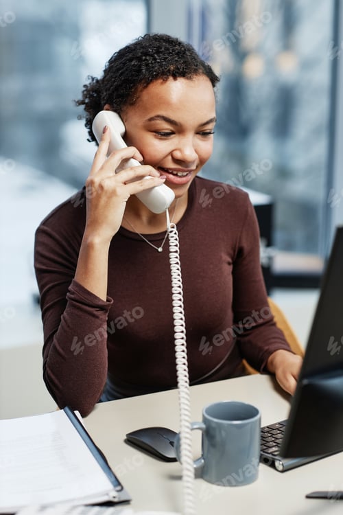 Preview: Secretary answering phone calls at desk in office