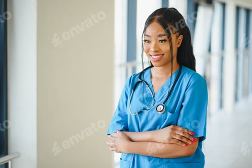 Preview: Smiling Woman Doctor in Scrubs with Stethoscope