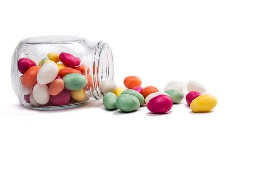 Colorful Candies Spill From a Glass Jar