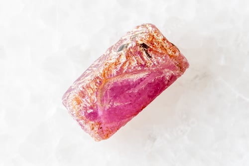 Preview: sample of raw pink ruby crystal on white marble