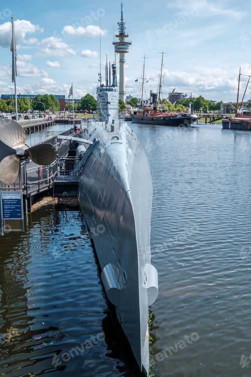 Preview: Vertical shot of a boat moored at a harbor on a sunny day