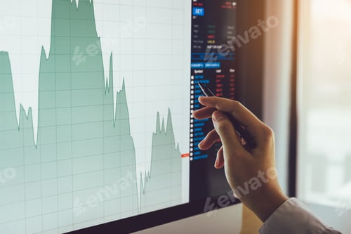 Preview: Close up of businessman hand pointing to stock market chart and analysis on computer screen.