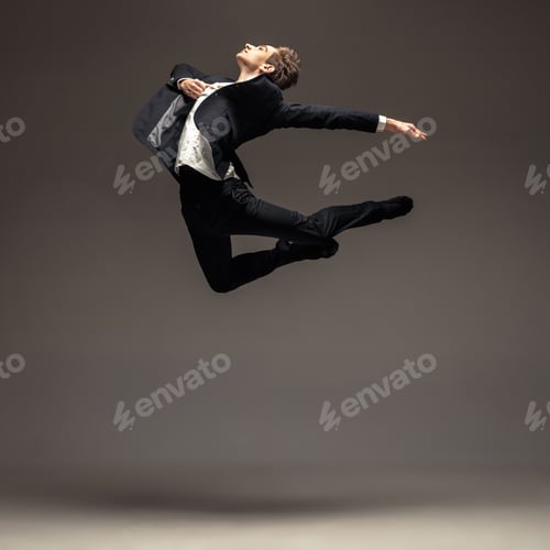 Preview: Man in casual office style clothes jumping isolated on studio background