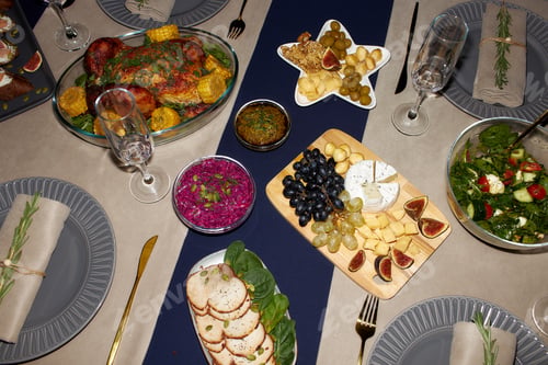 Preview: Cheese Platter and Roasted Chicken on Table Top with Plates and Glasses at Christmas