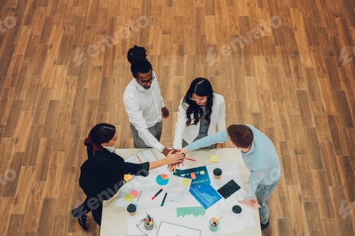 Preview: High angle shot of a multiracial business team having a meeting in office