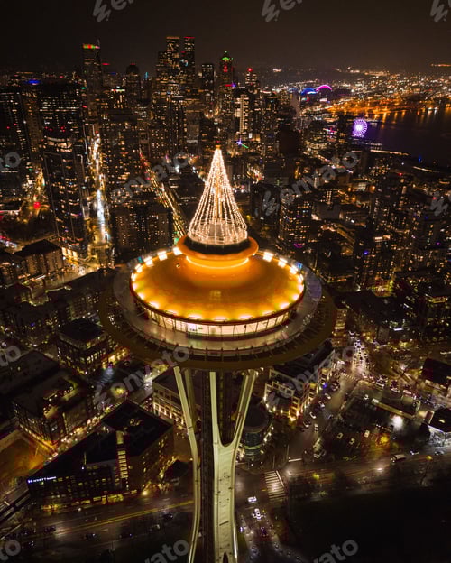 Preview: Iconic Seattle Space Needle against the city skyline, illuminated with festive Christmas lights