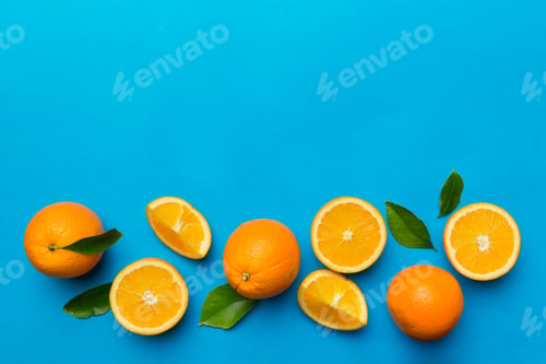 Preview: fresh Fruit orange slices on colored background. Top view. Copy Space.